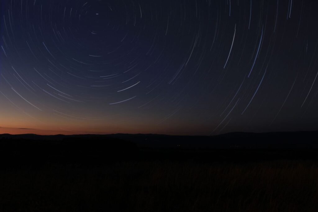 Time-lapse of star trails in the night sky, representing the celestial positions mapped in a Vedic birth chart