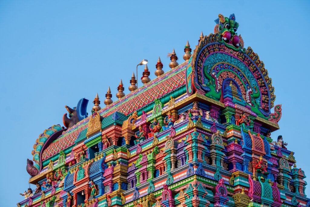 Vibrant colorful gopuram tower of Rameswaram Temple in India against a blue sky, representing the deep tradition behind Vedic astrology