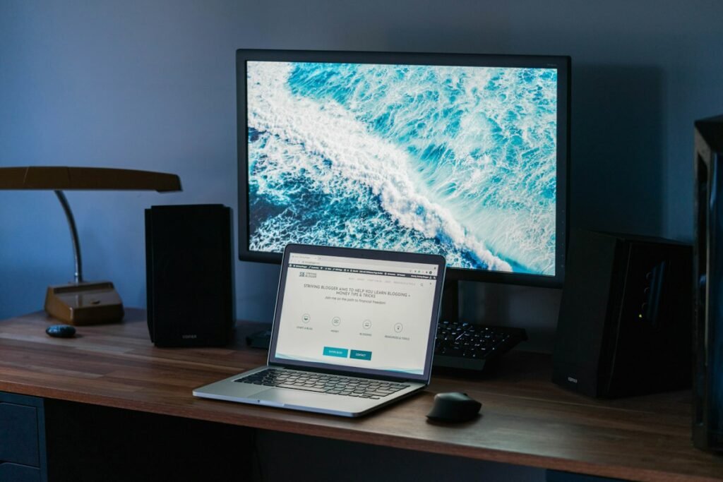 Free Kundli Calculators: What They Can and Cannot Tell You 2 Laptop and monitor on a wooden desk, where a free kundli calculator is typically used