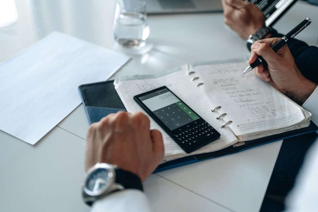 How Much Should a Vedic Astrology Report Cost? 5 Calculator and notebook used to work out what a Vedic astrology report should cost