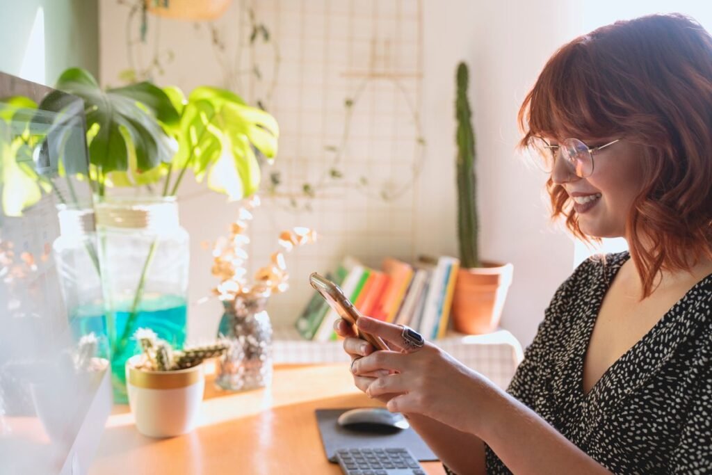 Vedic24 vs Astroyogi: Which Astrology Report Is Right for You? 8 Woman checking an astrology consultation app on her phone, comparing Vedic24 vs Astroyogi